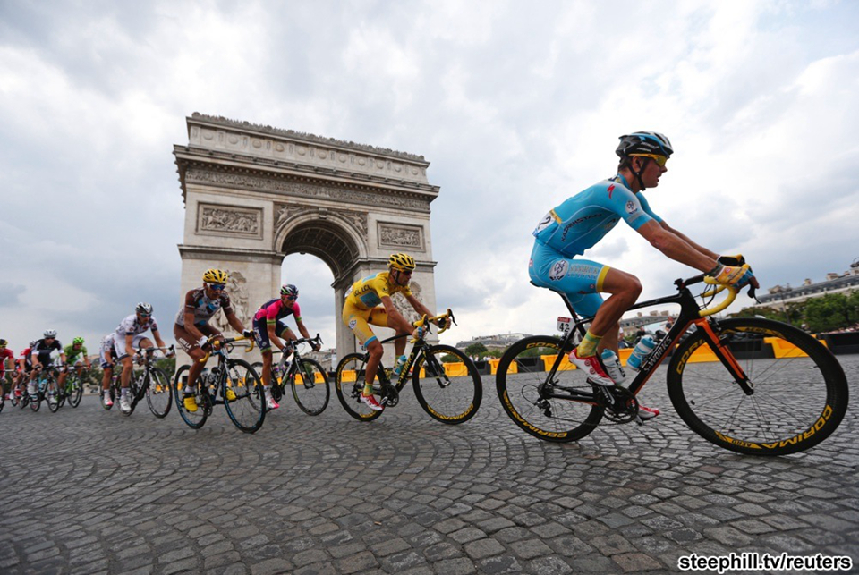 The race and race winner passing the Arc de Triomphe in Paris for the traditional circuits on the Champs-Elysées. Jean-Cristophe Peraud (left, 2nd overall) later crashed without injury on these cobbles.